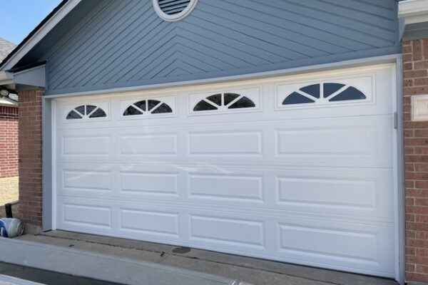 White garage door with decorative half-moon windows installed in Cleburne, Texas by Riverstone Garage Door Services